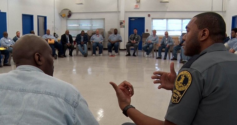 Virginia State Police officer speaks to offenders at State Farm Correctional Center